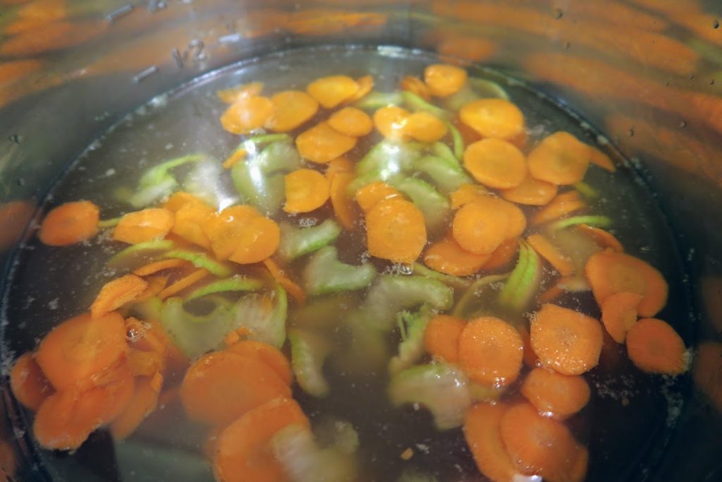 Sliced carrots, celery and onions in a chicken broth