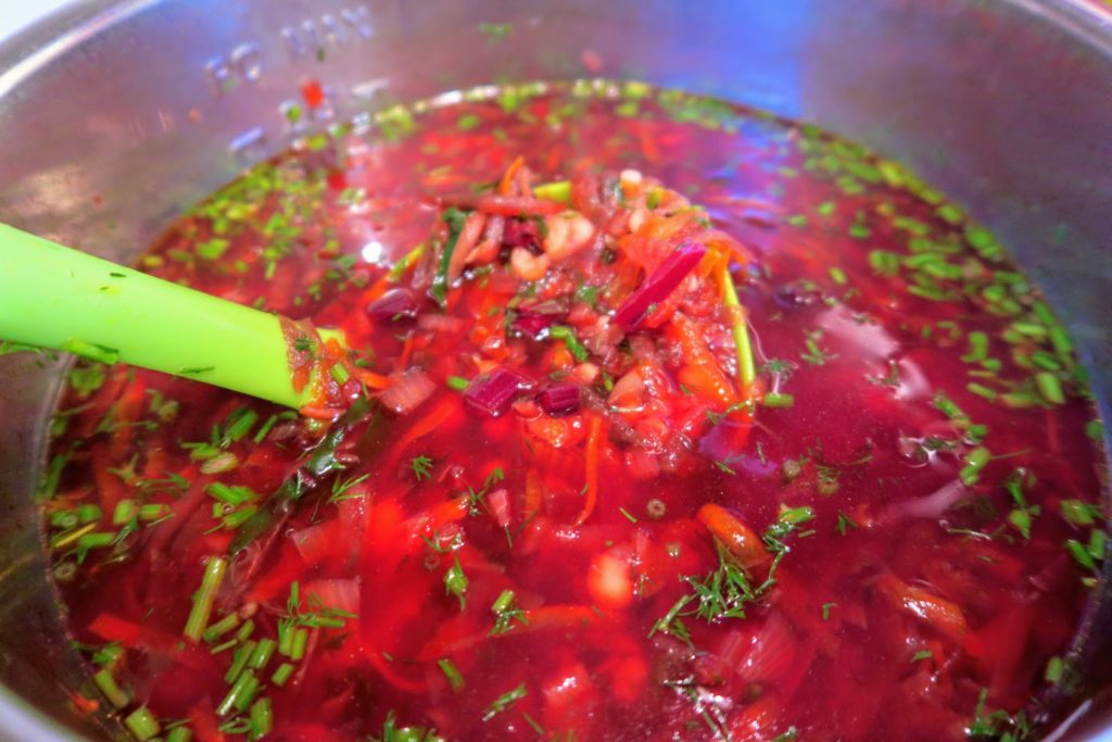 Cooked borscht with beans and dill added