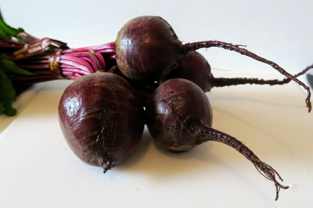 Four medium-sized beets with greens attached