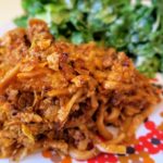 Saturday Night Noodleburg on a plate with some healthy green salad on the side