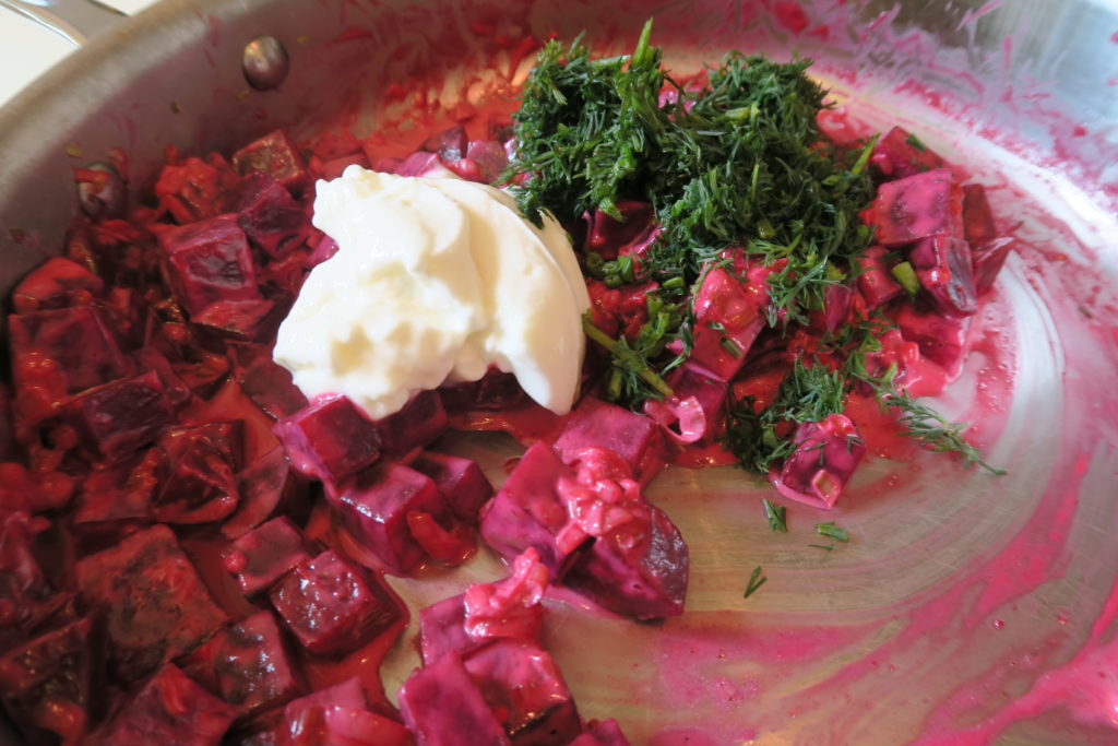 Adding sour cream and dill to the mixture of beets