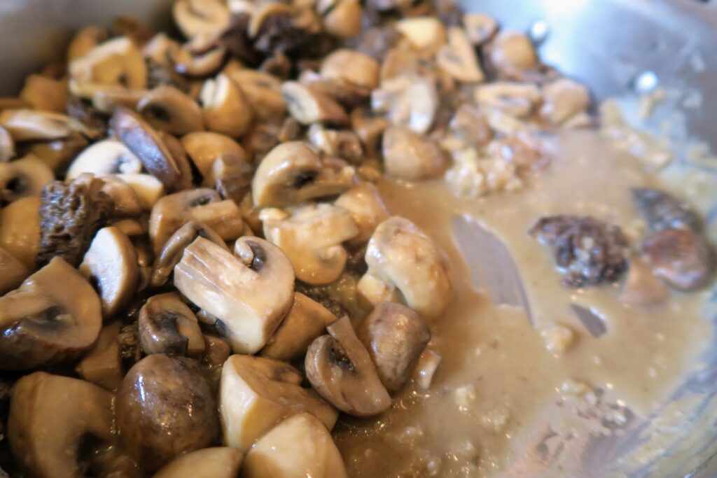 Flour mixed into the mushrooms and getting thicker
