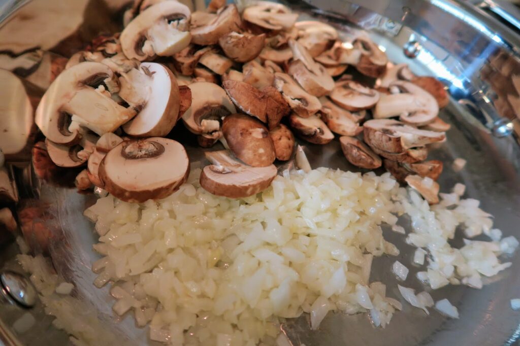 Mushrooms and onions in a frying pan