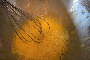 Beat eggs with a whisk