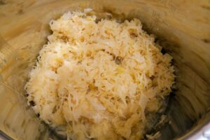 Layering the sauerkraut over the peas in the Instant Pot