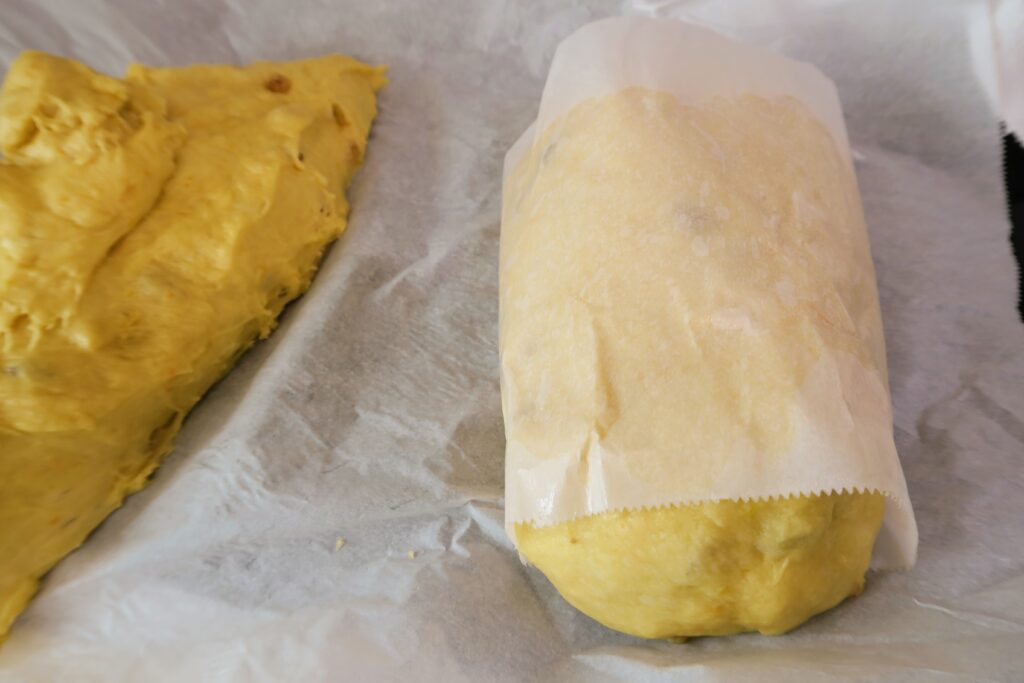 Parchment paper wrapped around the dough before sliding it into the can for baking